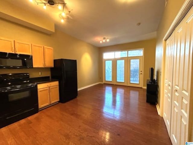 kitchen featuring black appliances, light brown cabinetry, and dark wood-type flooring