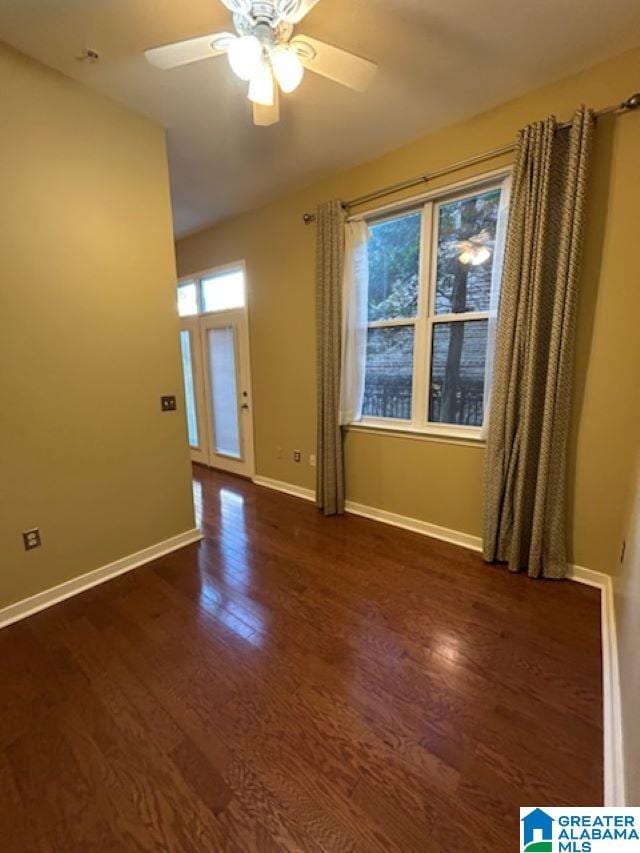 empty room featuring ceiling fan and dark wood-type flooring