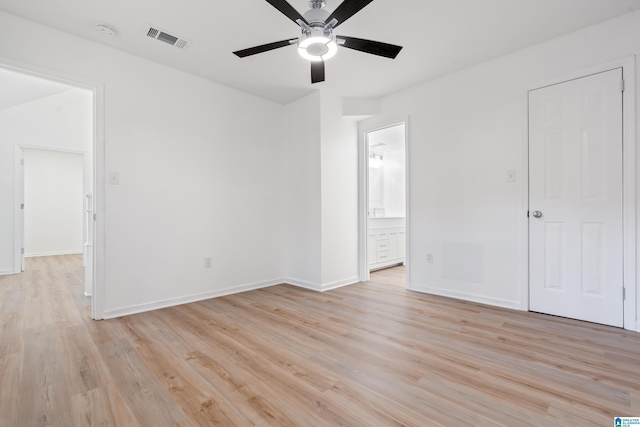 unfurnished bedroom with ceiling fan, ensuite bath, and light hardwood / wood-style flooring