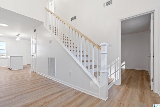 staircase with wood-type flooring