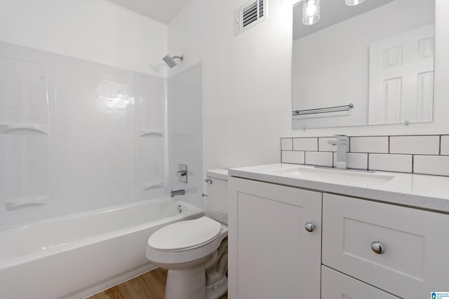 full bathroom with shower / bath combination, vanity, wood-type flooring, decorative backsplash, and toilet