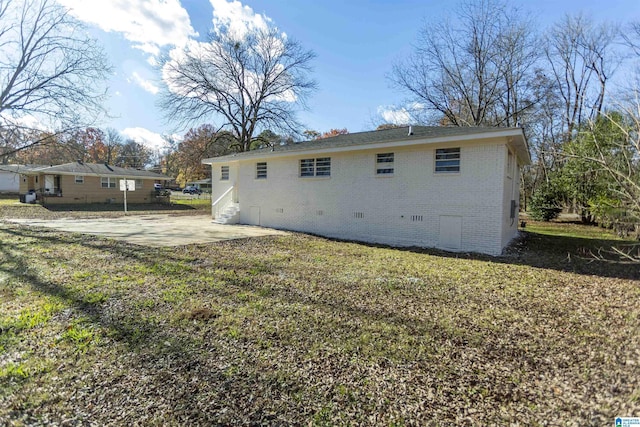 back of property with a patio area and a yard