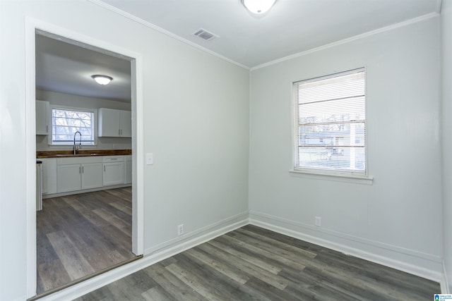 spare room featuring sink, crown molding, and dark hardwood / wood-style floors