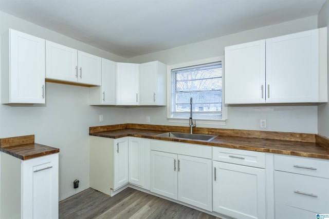 kitchen featuring sink, white cabinetry, wooden counters, and wood-type flooring