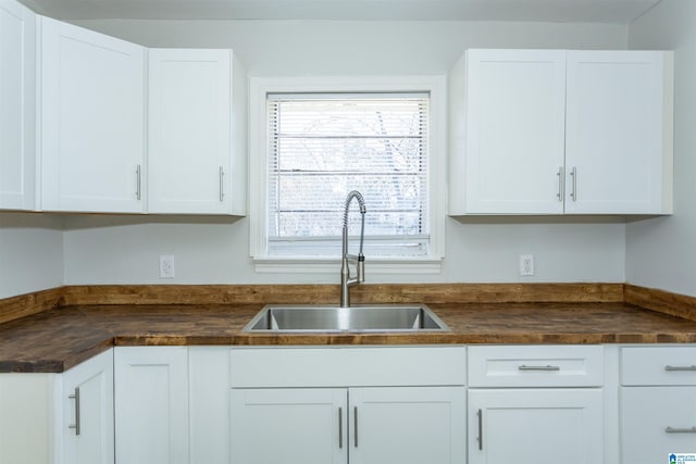 kitchen featuring sink and white cabinetry