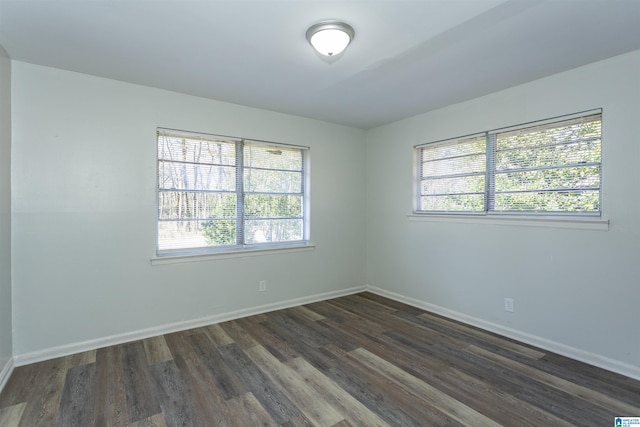 empty room with dark wood-type flooring