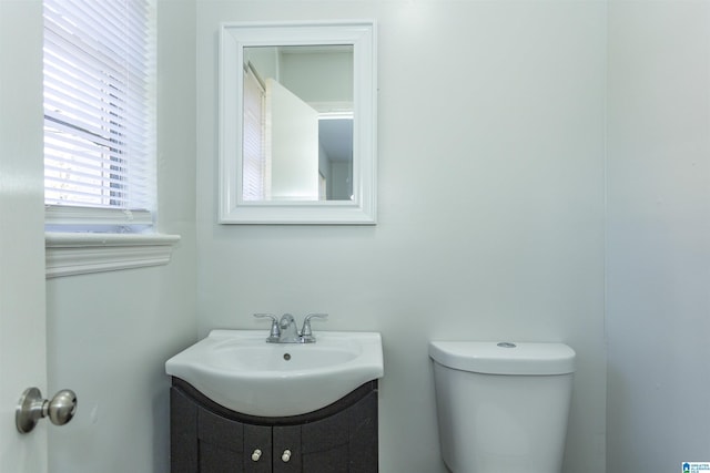 bathroom featuring toilet and vanity