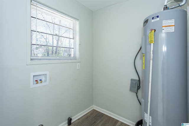 clothes washing area with hookup for a washing machine, hookup for an electric dryer, dark hardwood / wood-style flooring, and water heater