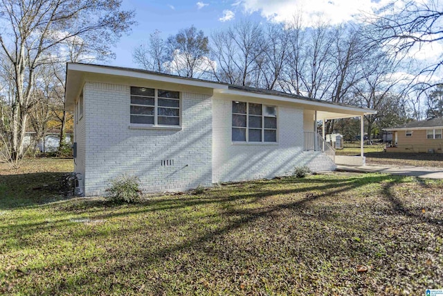 view of side of property with a yard