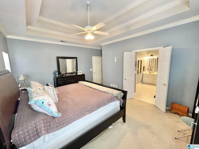 carpeted bedroom featuring crown molding and a tray ceiling