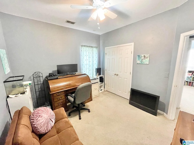 carpeted office featuring ceiling fan