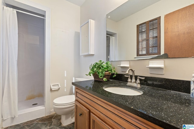 bathroom featuring toilet, a shower with shower curtain, and vanity