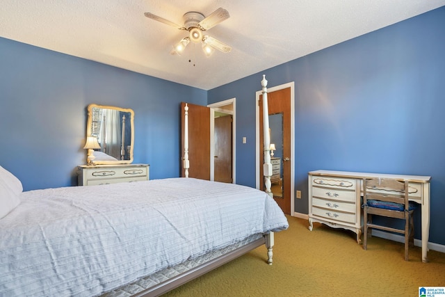 bedroom with ceiling fan, carpet, and a textured ceiling