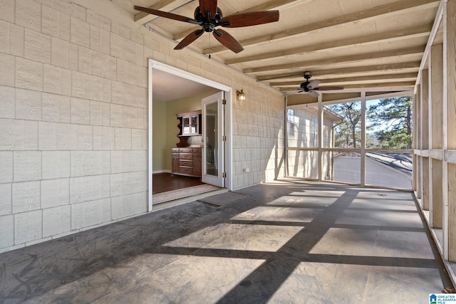 unfurnished sunroom with ceiling fan and beamed ceiling