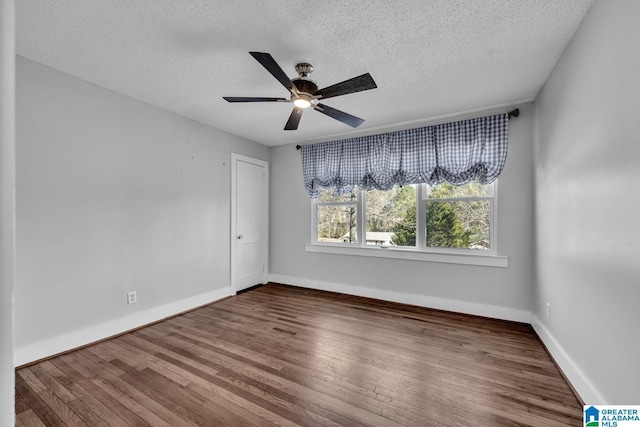 empty room featuring hardwood / wood-style floors, a textured ceiling, and ceiling fan