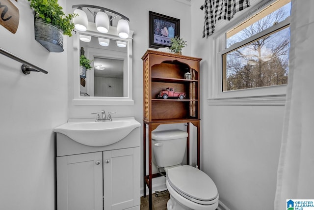 bathroom featuring toilet and vanity