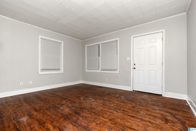 unfurnished room with crown molding and dark hardwood / wood-style floors