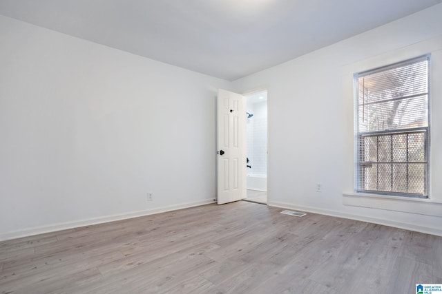 spare room with light wood-type flooring