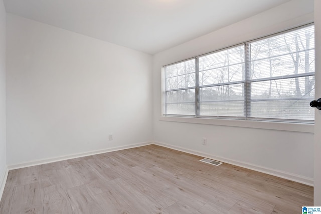 unfurnished room with light hardwood / wood-style floors