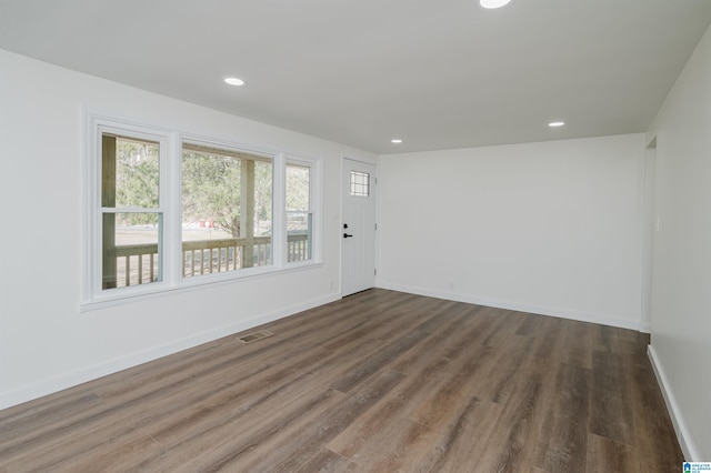 spare room with dark hardwood / wood-style floors