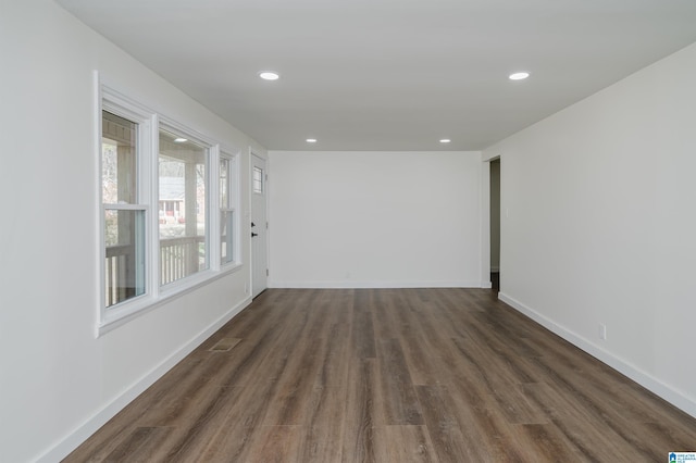 spare room featuring dark hardwood / wood-style flooring