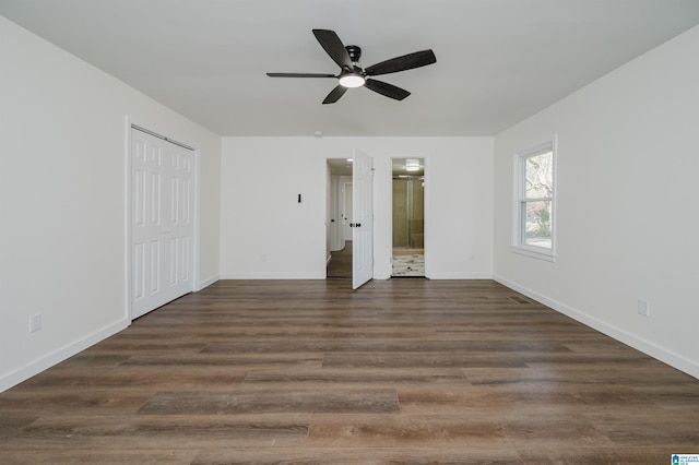 interior space with ceiling fan, ensuite bathroom, dark hardwood / wood-style flooring, and a closet