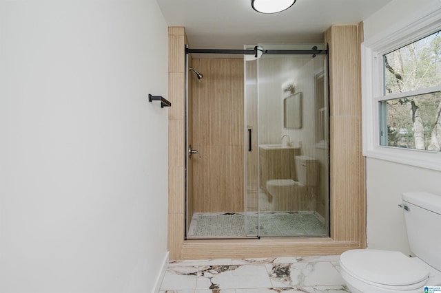 bathroom featuring toilet and walk in shower