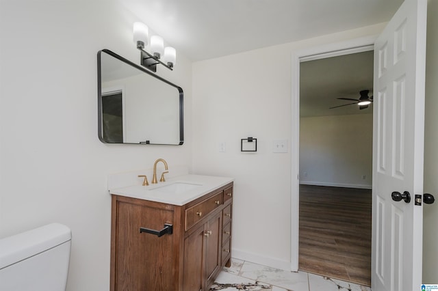 bathroom with vanity, toilet, and ceiling fan