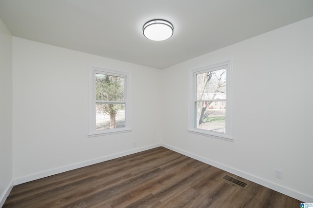 spare room featuring dark hardwood / wood-style flooring