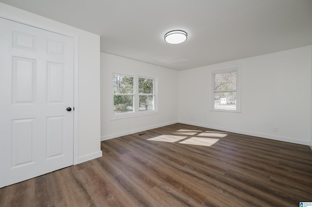 unfurnished bedroom featuring dark hardwood / wood-style floors