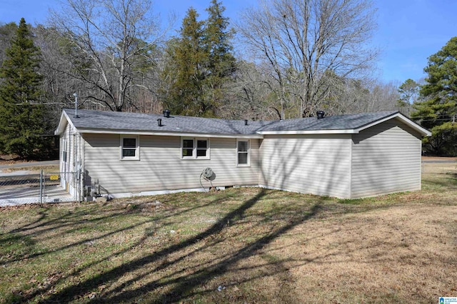 rear view of house with a yard