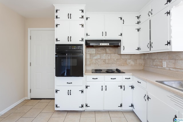 kitchen with black appliances, backsplash, white cabinetry, and light tile patterned flooring