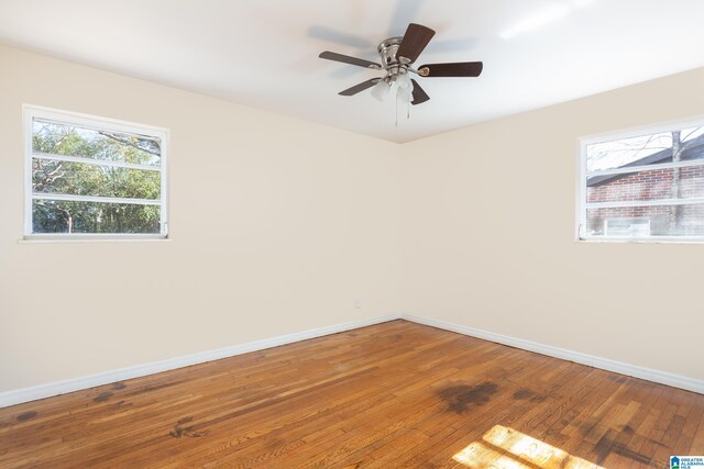 empty room featuring ceiling fan and hardwood / wood-style floors