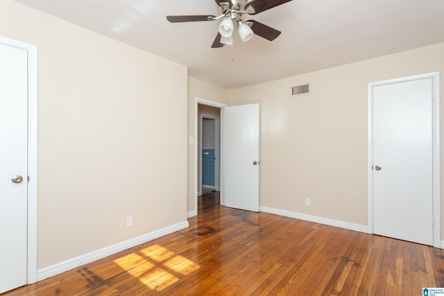 unfurnished bedroom featuring wood-type flooring and ceiling fan