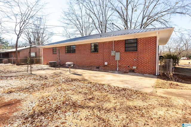 rear view of property with a patio area and central AC