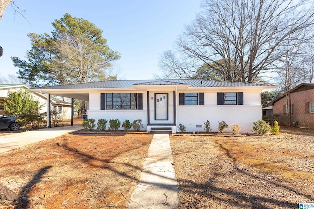 ranch-style home featuring a carport