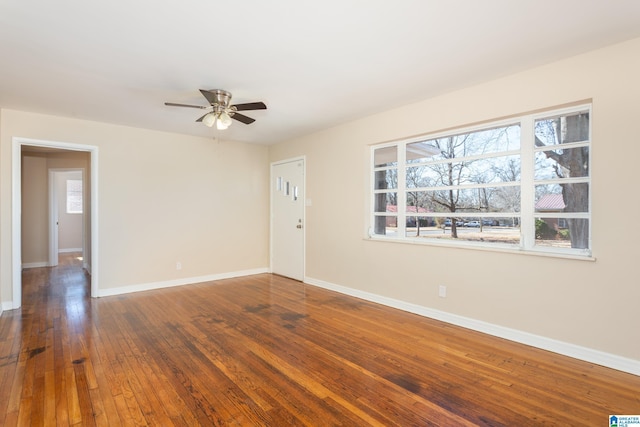 spare room with hardwood / wood-style flooring and ceiling fan