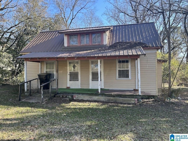 view of front of property with covered porch and a front yard