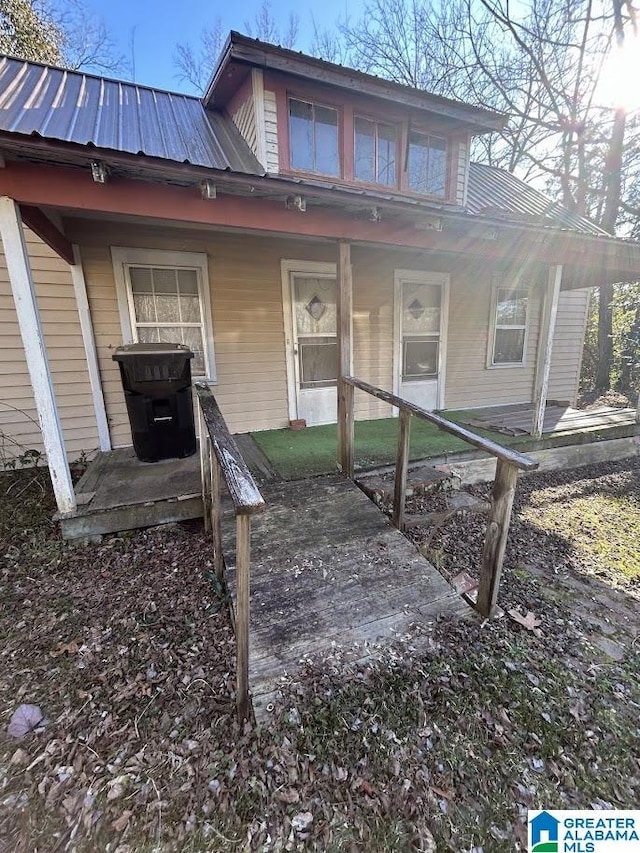 view of exterior entry featuring covered porch