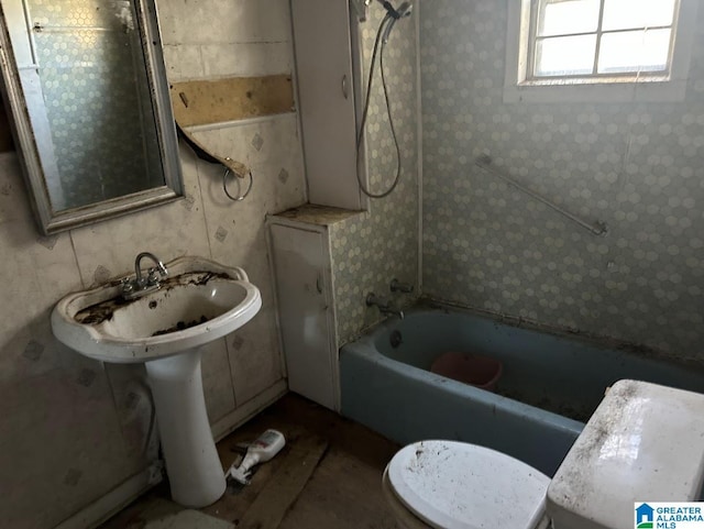 bathroom with toilet and  shower combination