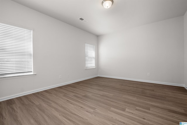 spare room with hardwood / wood-style flooring