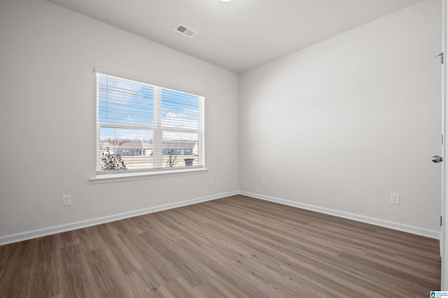 empty room with hardwood / wood-style flooring