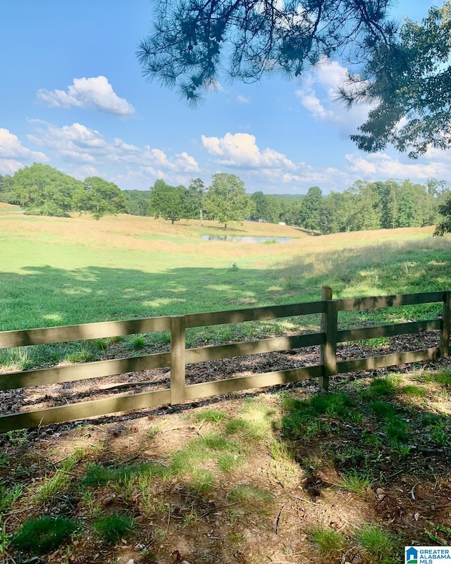 view of gate featuring a yard and a rural view