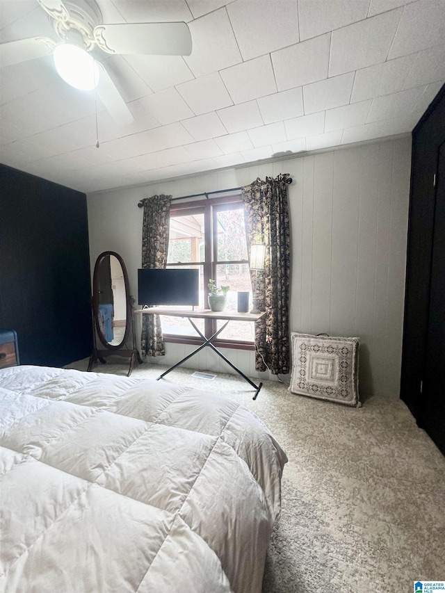 bedroom with ceiling fan and carpet