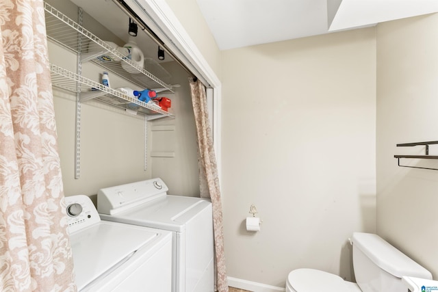 clothes washing area with washing machine and dryer