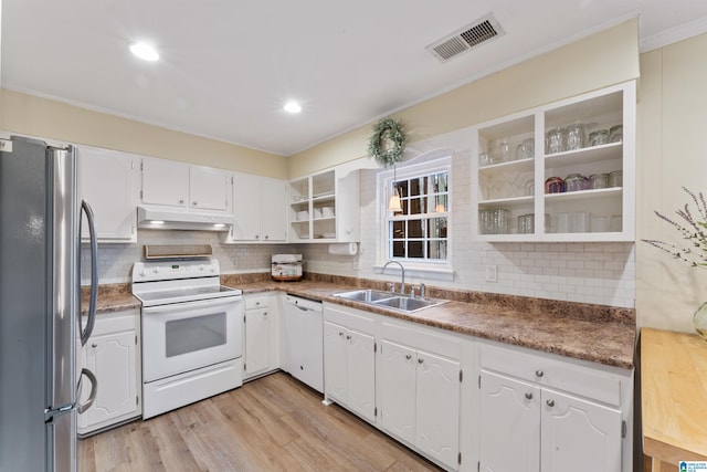 kitchen with white cabinetry, sink, backsplash, light hardwood / wood-style floors, and white appliances