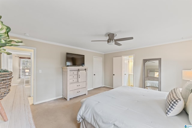 bedroom featuring light carpet, ornamental molding, ceiling fan, and ensuite bathroom