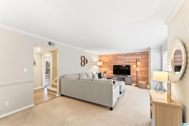 carpeted living room with ornamental molding and wooden walls