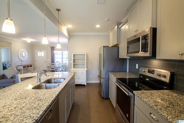 kitchen featuring hanging light fixtures, light stone countertops, appliances with stainless steel finishes, and sink