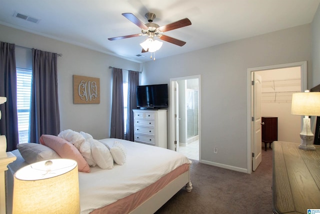 bedroom featuring carpet flooring, a spacious closet, ceiling fan, ensuite bath, and a closet